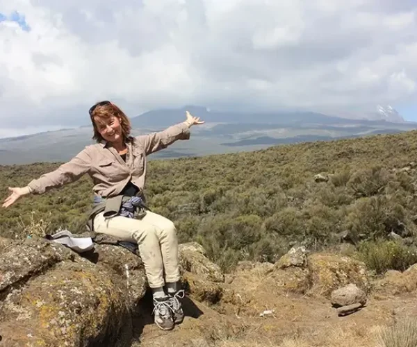 Woman resting on the Shira Plateau during a Kilimanjaro day hike