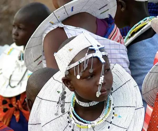 Maasai girls in traditional attire at Olpopongi Maasai Village, showcasing culture on Olpopongi Maasai Village Day Trip