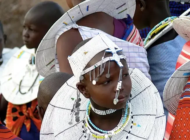 Maasai girls in traditional attire at Olpopongi Maasai Village, showcasing culture on Olpopongi Maasai Village Day Trip