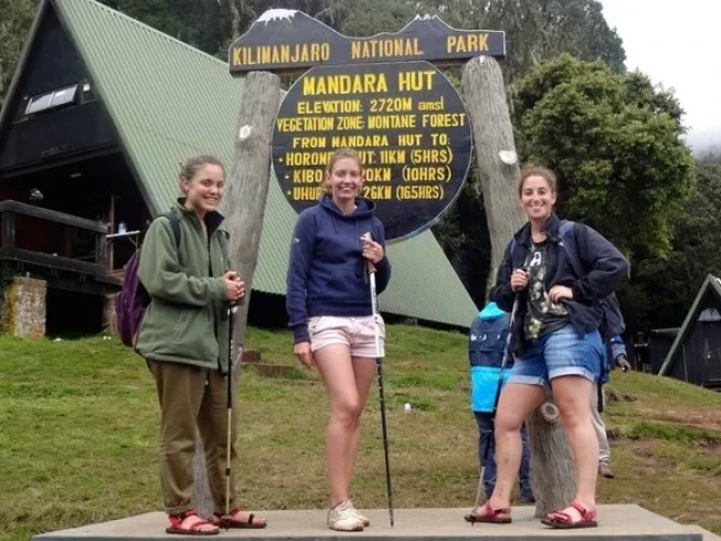 Girls posing at Mandara Hut on the Kilimanjaro day hike via the Marangu Route