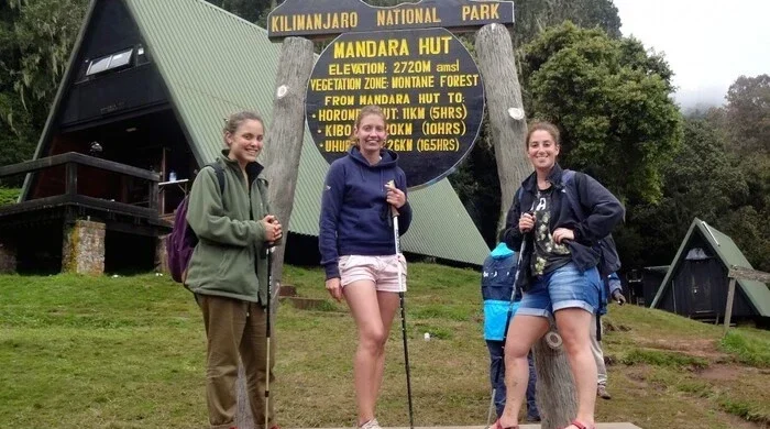 Girls posing at Mandara Hut on the Kilimanjaro day hike via the Marangu Route